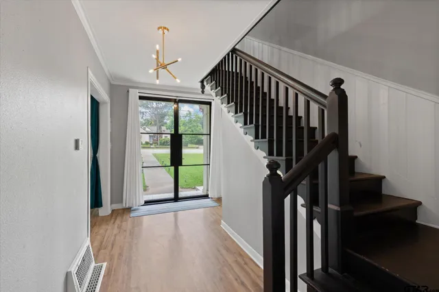 a view of entryway and hall with wooden floor