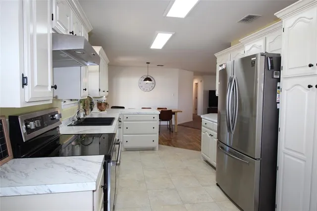 a kitchen with a refrigerator sink and stove