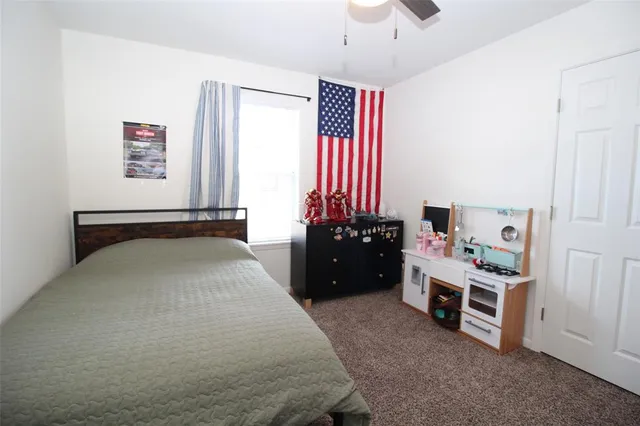a bedroom with furniture and a baby crib