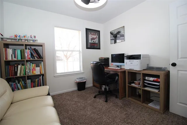 a view of a workspace with a bookshelf
