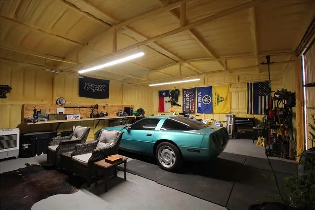 a living room with furniture a flat screen tv and kitchen view