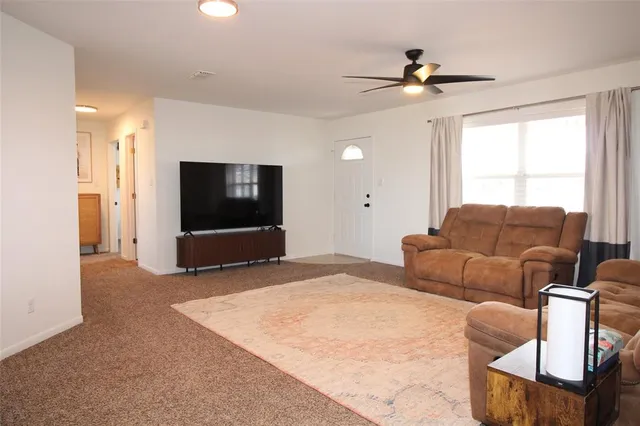 a living room with couches and a flat screen tv