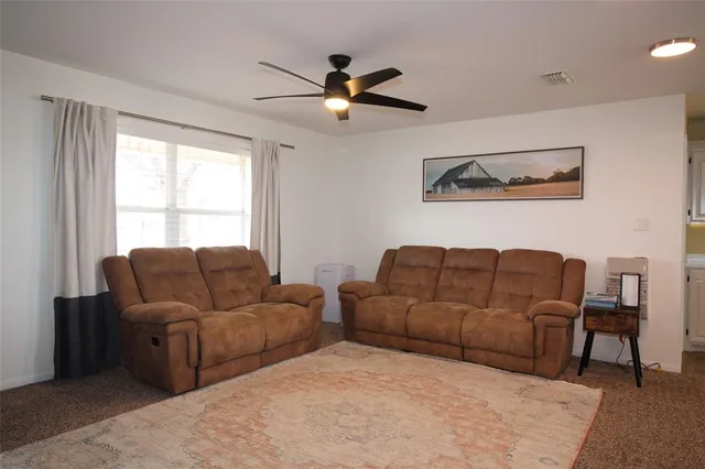 a living room with couches and a window