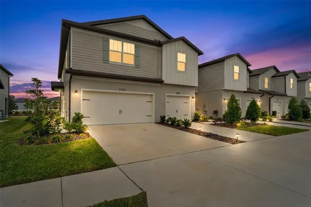 a front view of a house with a yard and garage