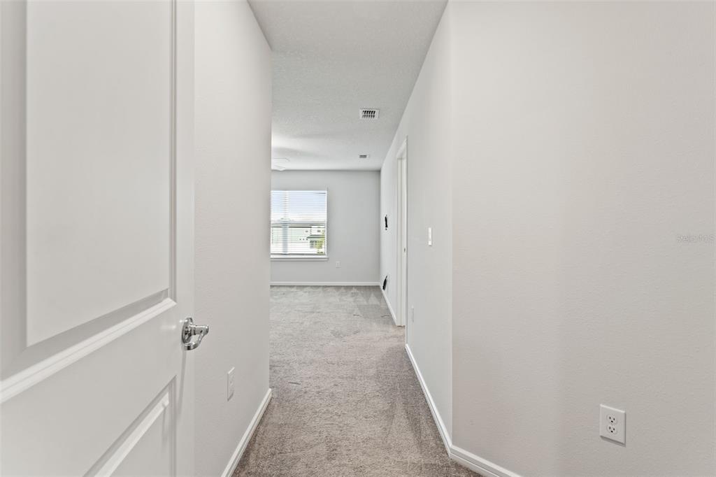 31329 Amberview Bend Wesley Chapel, FL 33545 - Photo 15 of 57 a view of a bathroom from the hallway