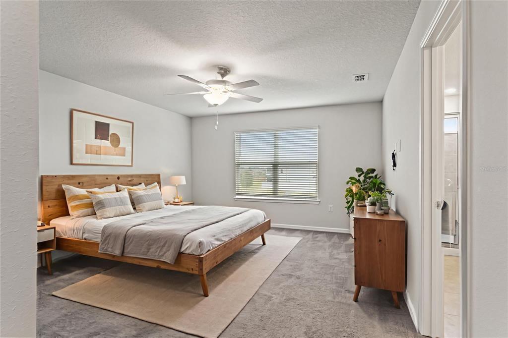 31329 Amberview Bend Wesley Chapel, FL 33545 - Photo 16 of 57 a bedroom with a bed and a chandelier