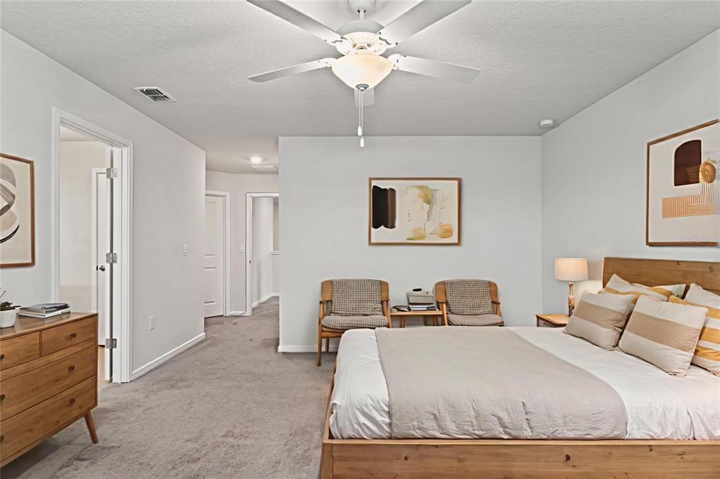 31329 Amberview Bend Wesley Chapel, FL 33545 - Photo 17 of 57 a bedroom with a bed and a chandelier