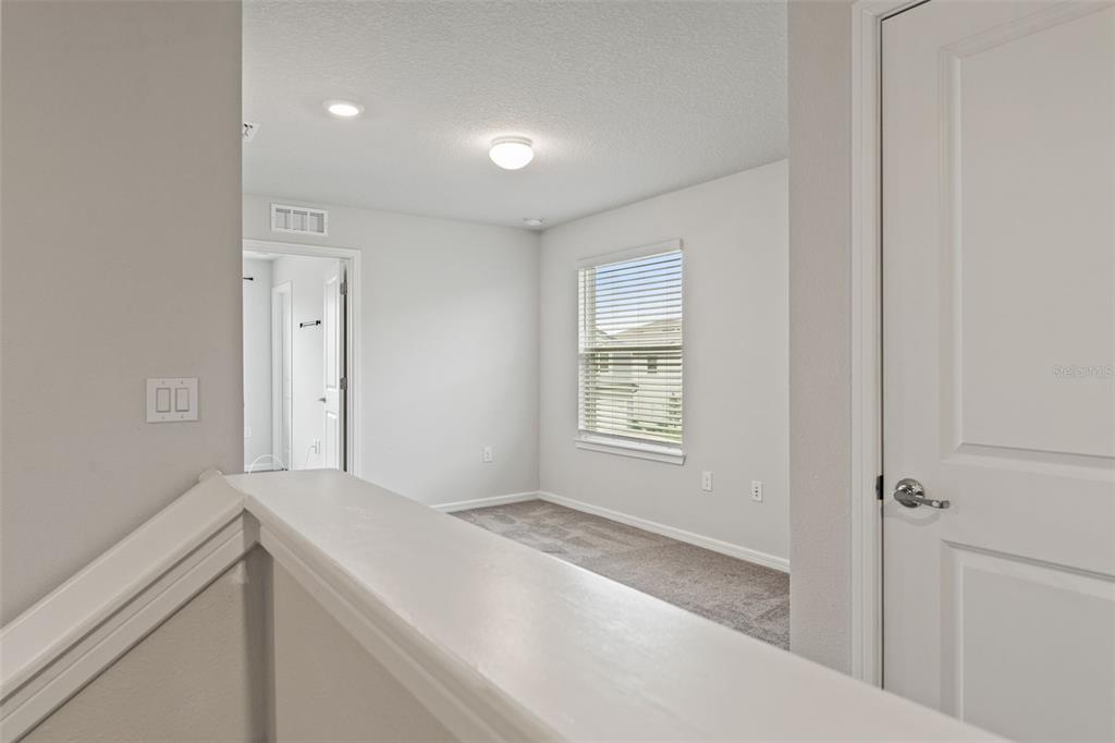 31329 Amberview Bend Wesley Chapel, FL 33545 - Photo 28 of 57 a room with a bed and a window