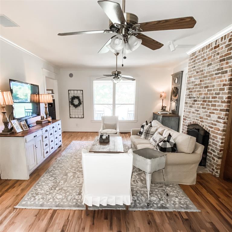 581 Country Club Road Fairview, TX 75069 - Photo 22 of 39 a living room with furniture and a fireplace