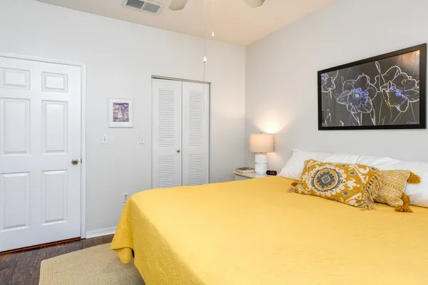 a bedroom with a bed and lamp