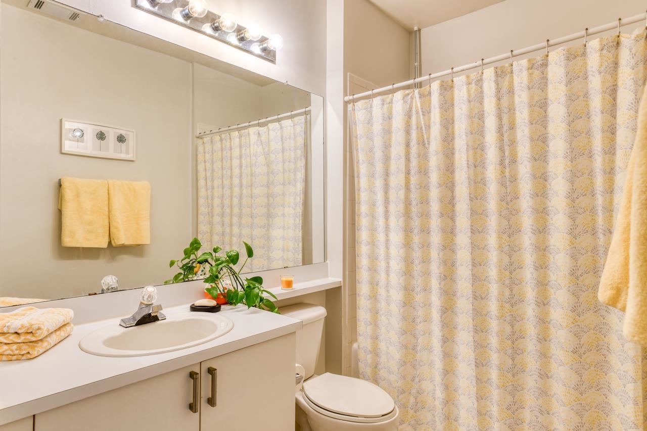 605 Fairway Drive, Unit 203 St. Augustine, FL 32084 - Photo 14 of 35 a bathroom with a sink a toilet and a window