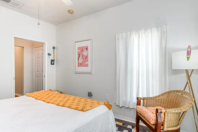 a bedroom with a bed and a chair