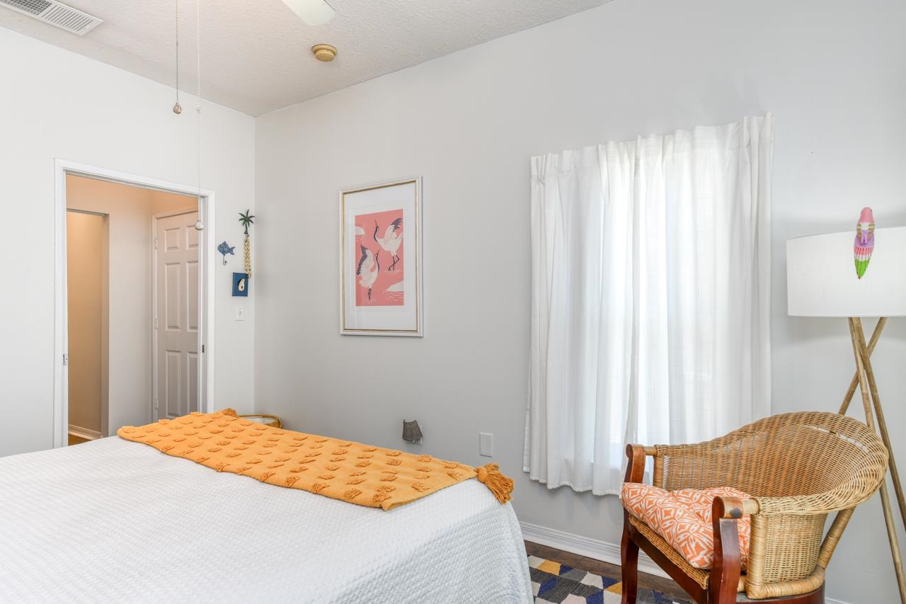 605 Fairway Drive, Unit 203 St. Augustine, FL 32084 - Photo 17 of 35 a bedroom with a bed and a chair