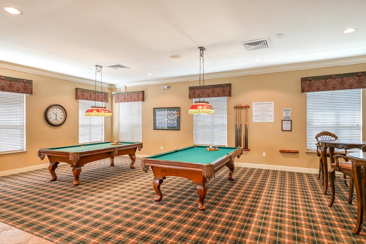 605 Fairway Drive, Unit 203 St. Augustine, FL 32084 - Photo 26 of 35 a living room with furniture a dining table and paintings on the wall