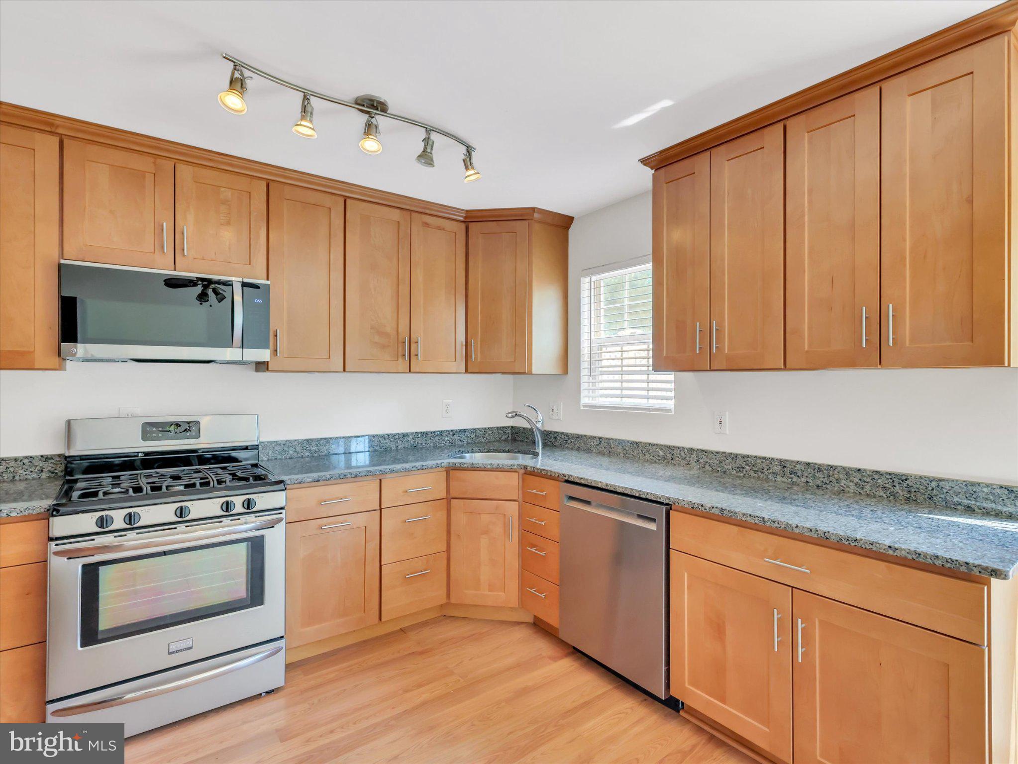 14323 Gate Dancer Lane Boyds, MD 20841 - Photo 32 of 54 Modern kitchen with warm wood tones.