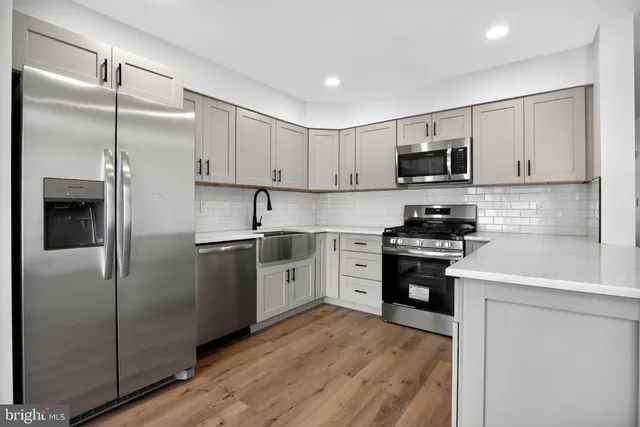 a kitchen with cabinets stainless steel appliances and a counter space