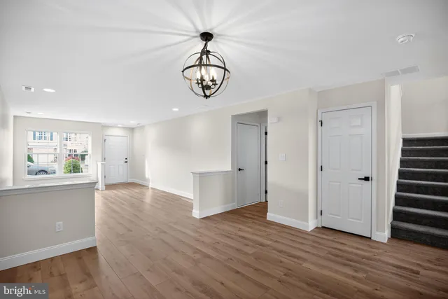 an empty space with wooden floor and windows
