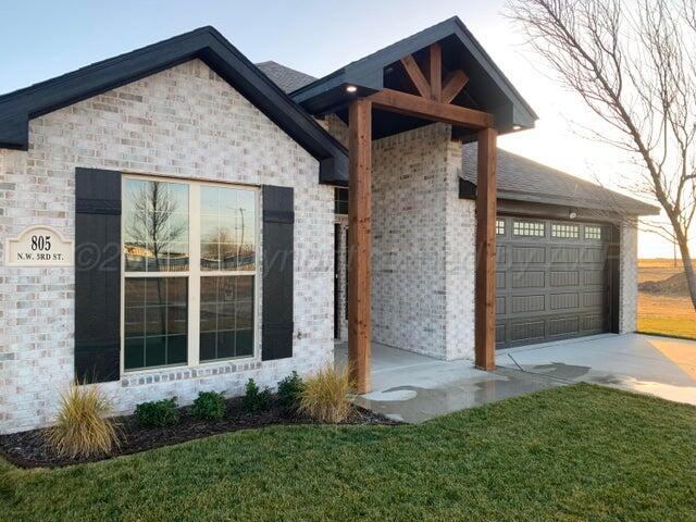 805 Northwest 3rd Street Happy, TX 79042 - Photo 2 of 13 a front view of a house with garden