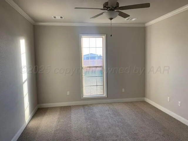 an empty room with a window and a fan