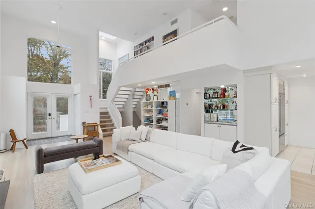 a living room with furniture a rug and a large window