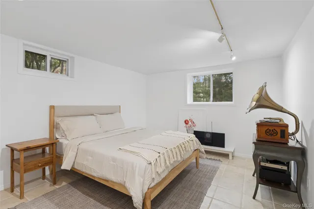 a bathroom with a granite countertop sink a large mirror and a shower