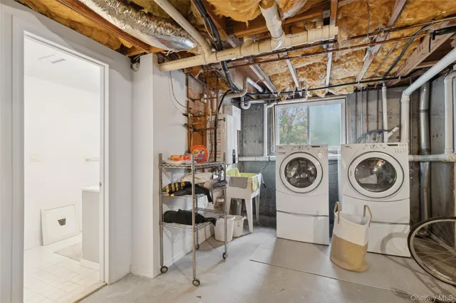 a hallway with a large window and kitchen view