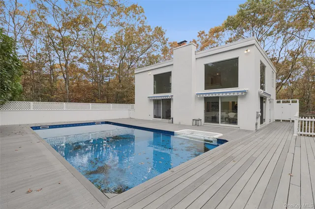 a view of a balcony with wooden floor and fence