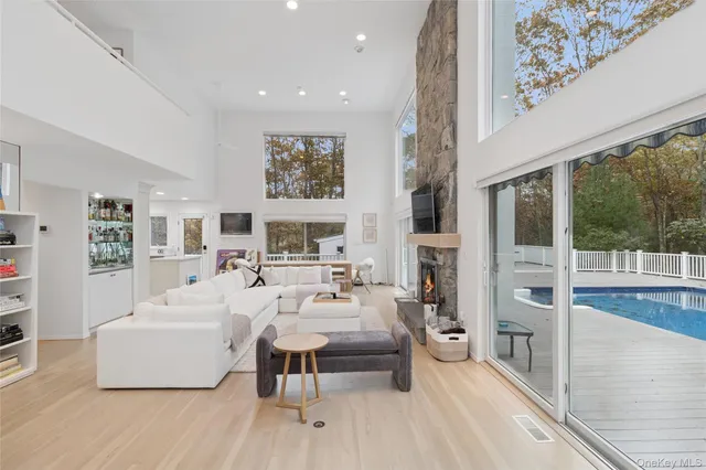 a living room with furniture a large window and a table