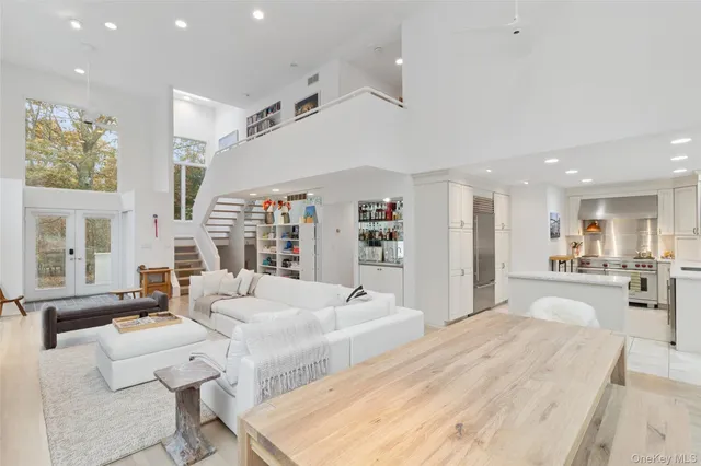 a large white kitchen with cabinets