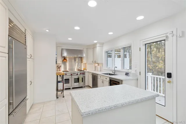 a open kitchen with sink and refrigerator