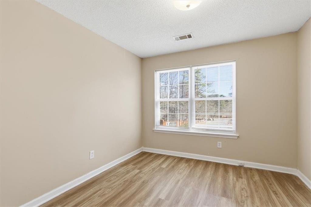 460 Parkway Road Union City, GA 30291 - Photo 15 of 18 an empty room with wooden floor and windows