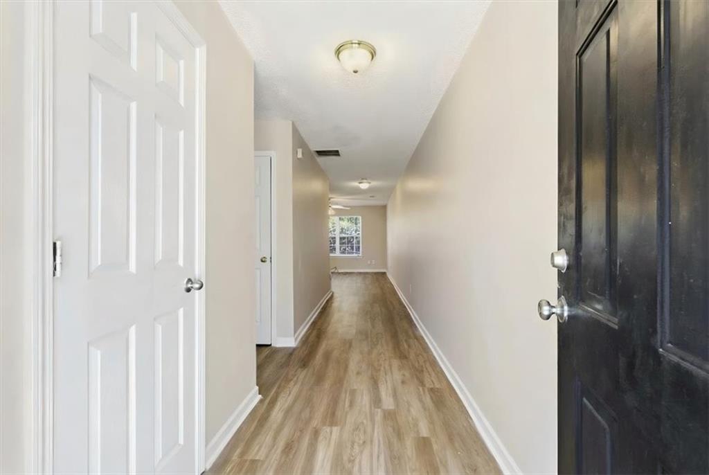 460 Parkway Road Union City, GA 30291 - Photo 4 of 18 a view of a hallway with wooden floor and staircase