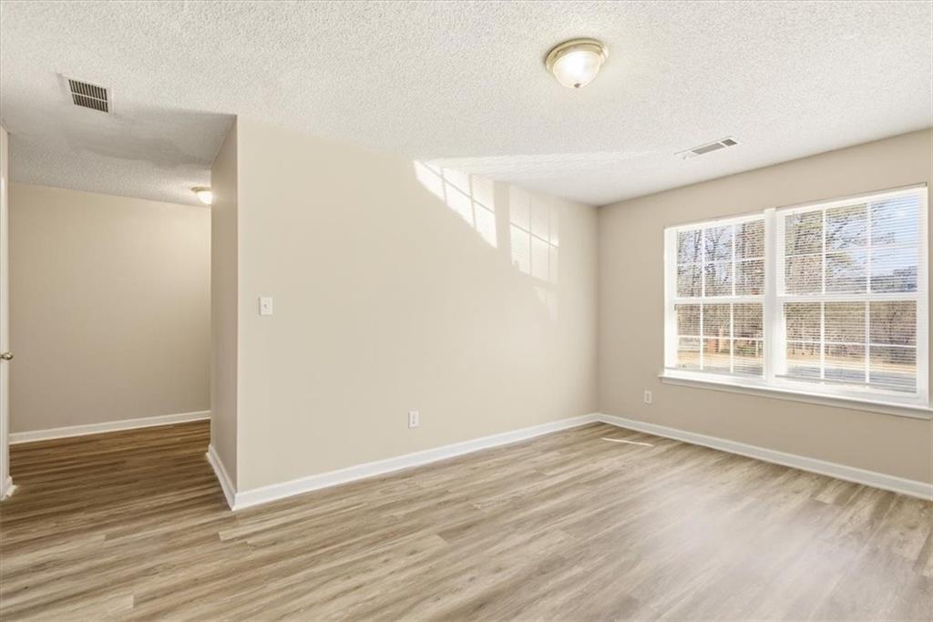 460 Parkway Road Union City, GA 30291 - Photo 6 of 18 a view of an empty room with wooden floor and a window