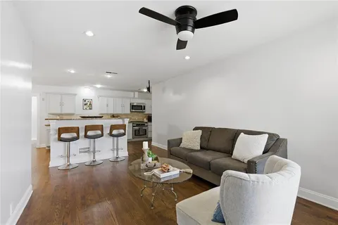 a living room with furniture and kitchen view