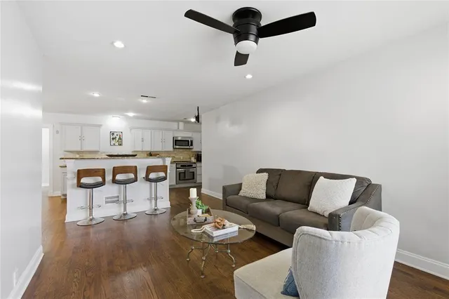 a living room with furniture and kitchen view