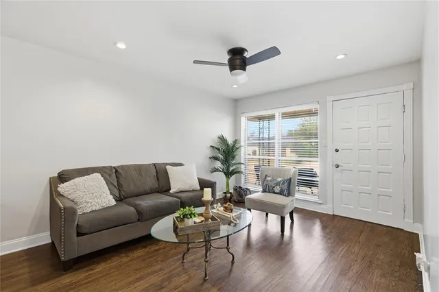a living room with furniture and wooden floor