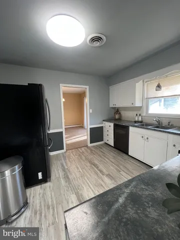 a large kitchen with stainless steel appliances granite countertop a stove a sink and a refrigerator