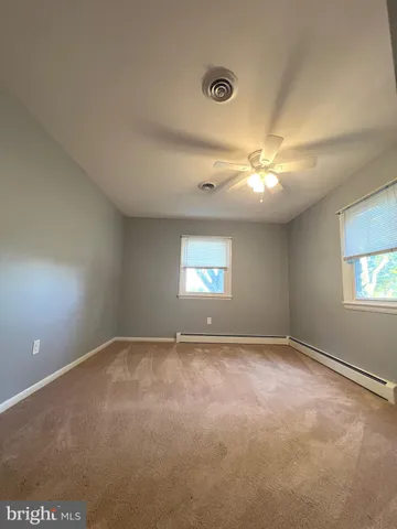 a view of an empty room with a fireplace