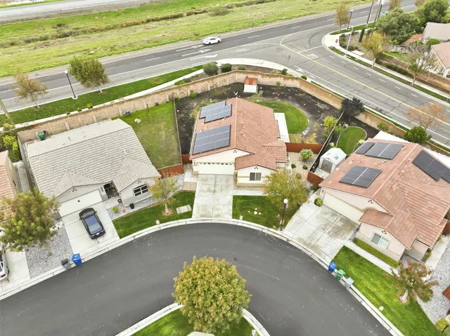 an aerial view of a house with a yard