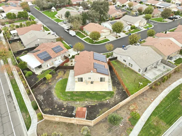 a view of a house with a wooden fence