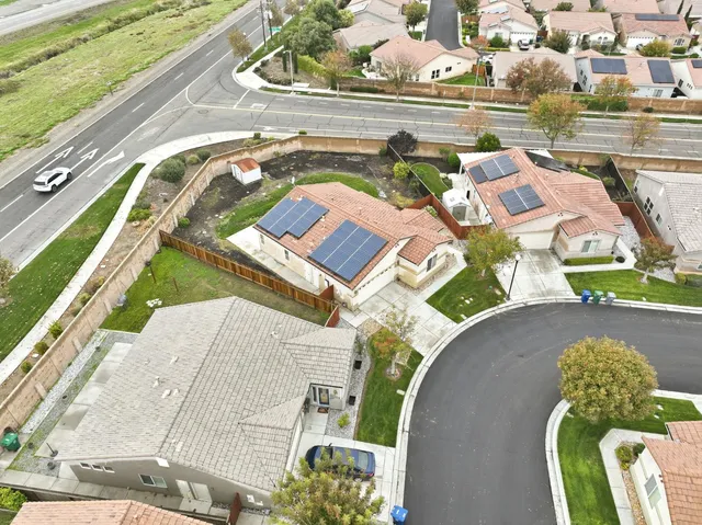 a white house that has a tree in front of it