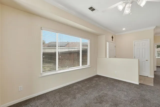 an empty room with a ceiling fan