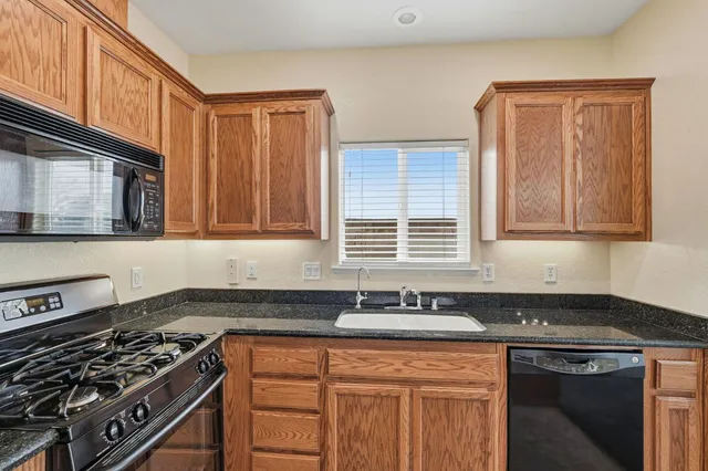 an empty room with a chandelier fan