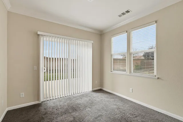 an empty room with fan and entrance