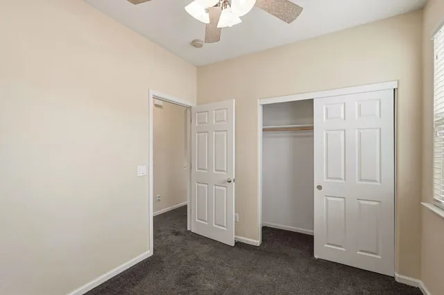 a bathroom with a granite countertop sink toilet a large mirror and shower