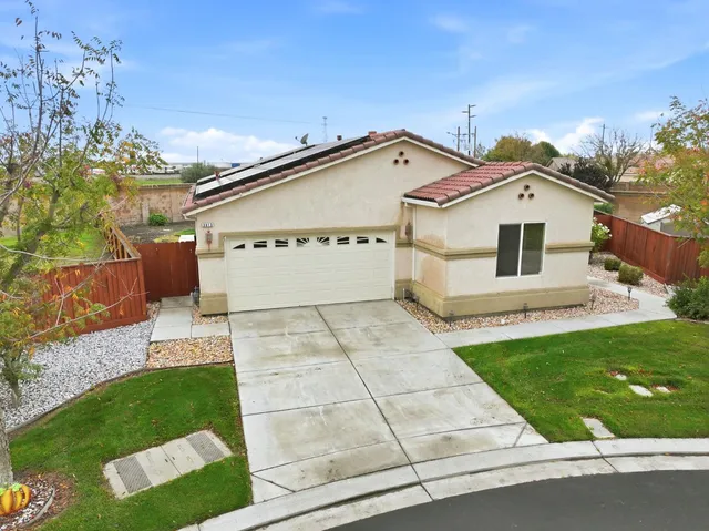 an aerial view of a house with garden space and street view