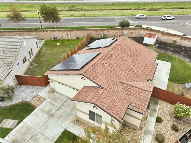 an aerial view of a house with a garden and lake view