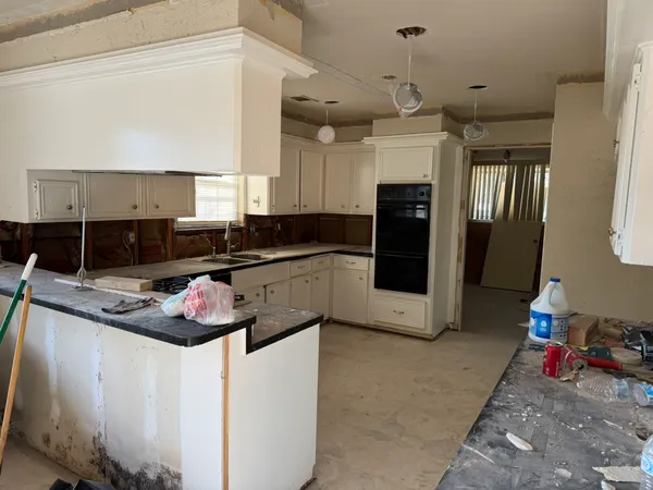 a kitchen with stainless steel appliances granite countertop a sink and cabinets