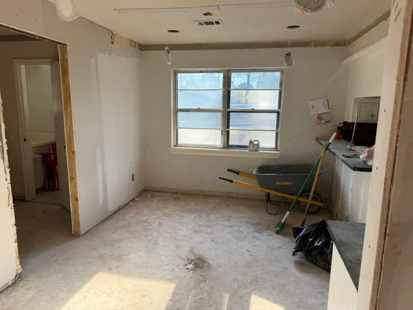 a view of a workspace with furniture and a window