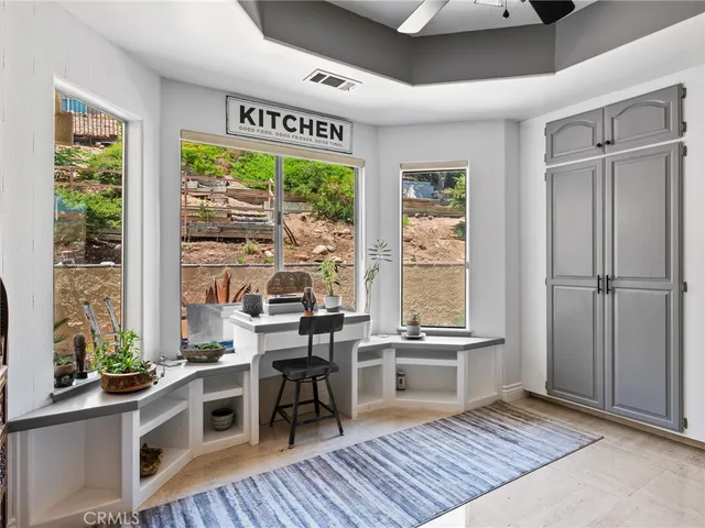 a living room with fireplace furniture and a floor to ceiling window